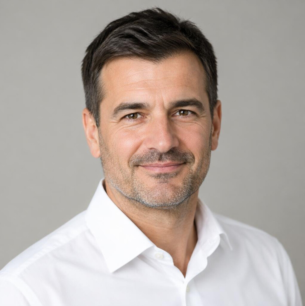 Portrait of a middle-aged man with short dark hair in a shirt