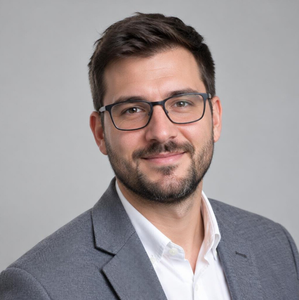 Portrait of a young man with a beard and glasses
